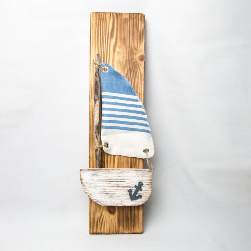 Kleines Segelboot auf Holzbrett